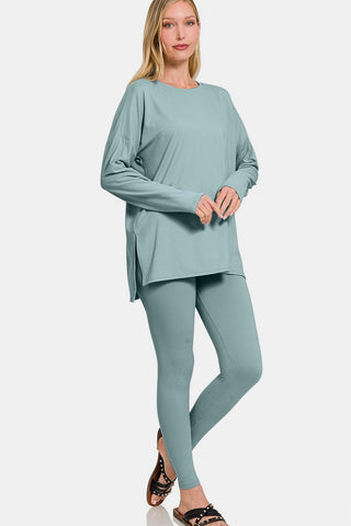 Woman wearing a chic brushed microfiber lounge set with top and leggings in teal, featuring a trendy slit detail.
