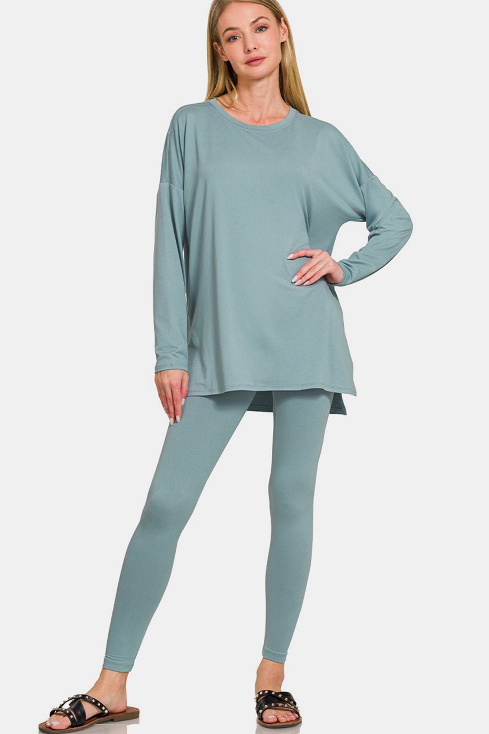 Woman wearing blue brushed microfiber top and leggings lounge set, showcasing trendy slit detail and comfortable fit.