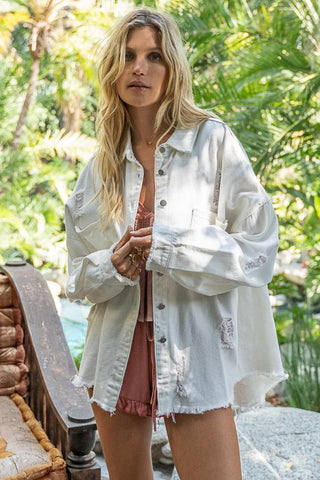 Woman wearing Button Down Raw Hem Distressed Shacket in outdoor setting