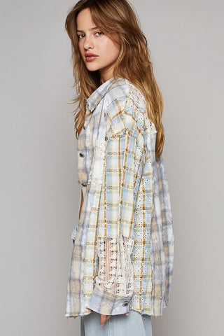 Woman in long sleeve embroidered crochet plaid shirt with lace details, side view, casual fashion style.