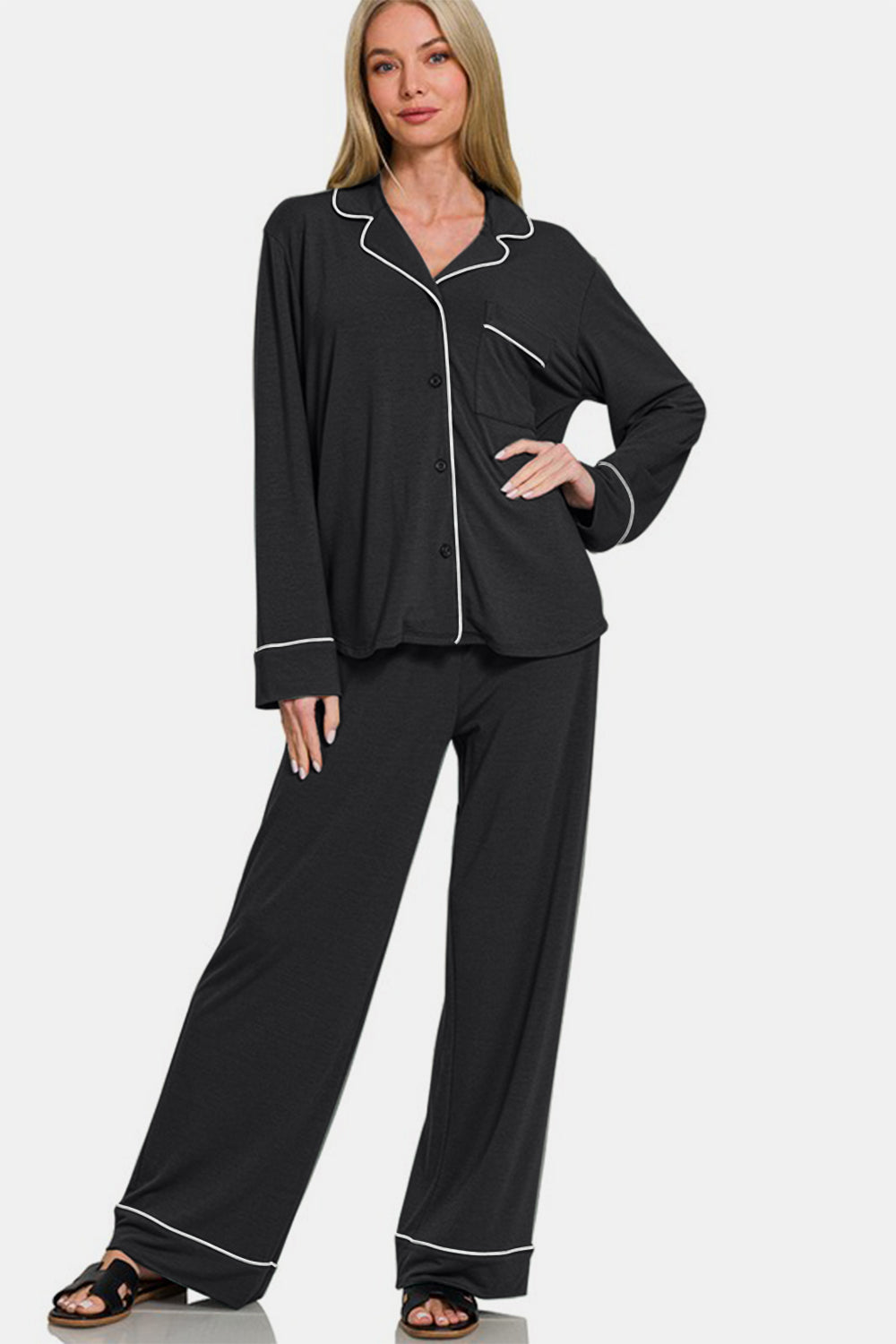 Woman wearing black button down long sleeve top and pants lounge set with pockets, basic style, slightly stretchy fabric.