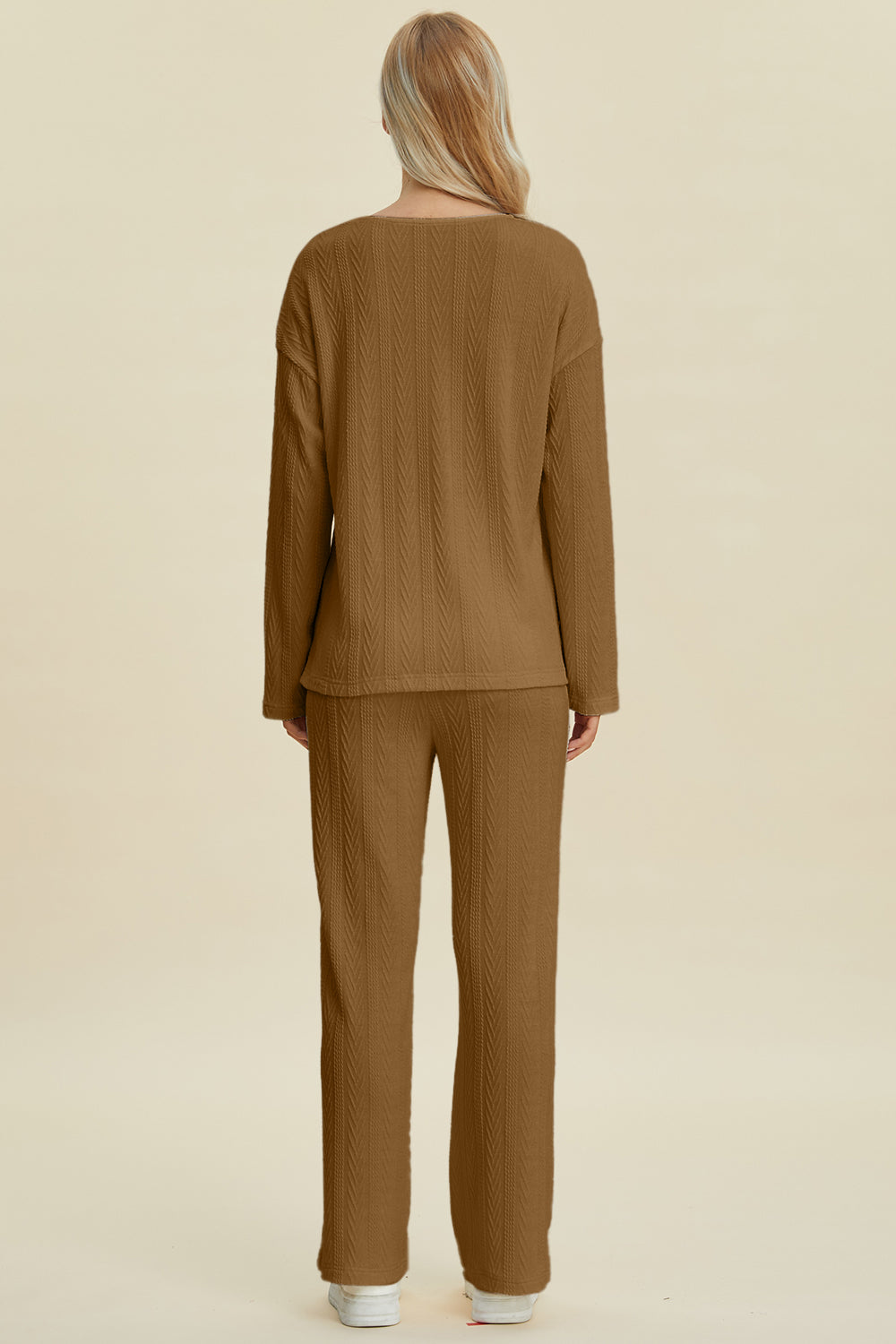 Back view of a brown cable-knit long sleeve top and pants set, featuring a buttoned design with slightly stretchy polyester-spandex material.