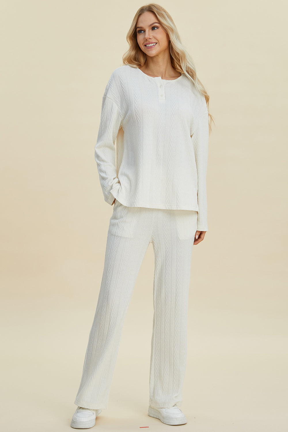 Woman wearing cable-knit long sleeve top and pants set with buttoned design, made of 95% polyester and 5% spandex.