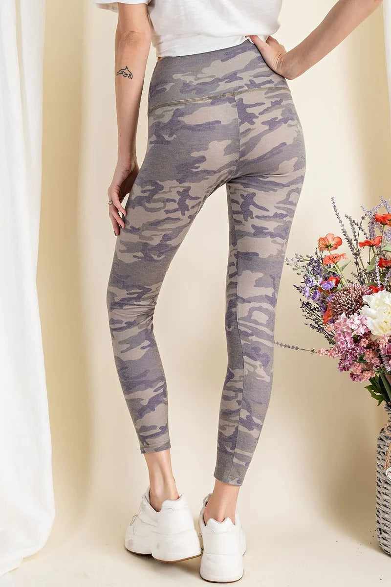 Olive camouflage printed rayon spandex leggings, mid-rise and lightweight, shown from behind with a bouquet of flowers in the background.