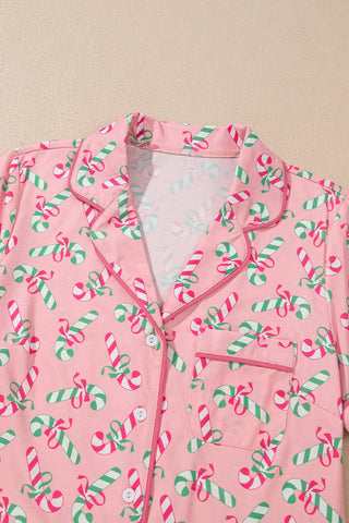 Pink candy cane collared neck pajama top with green and red festive design.