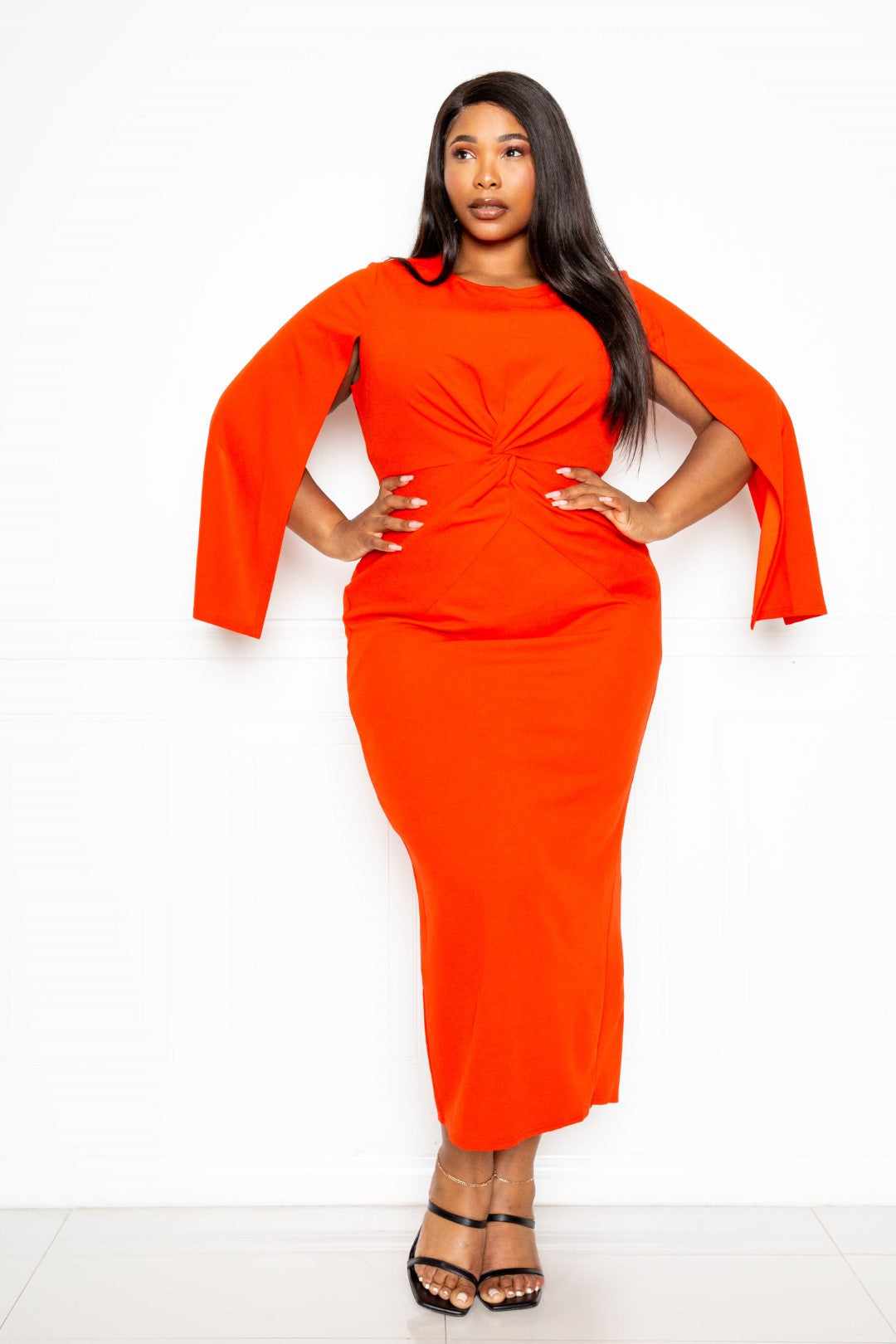 Orange-red cape sleeve dress with knot detail in plus sizes 1XL to 3XL, made from 95% polyester and 5% spandex for a comfy fit.