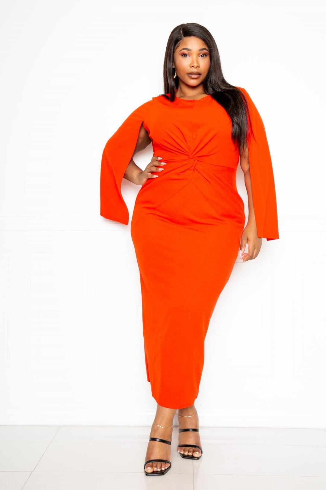 Orange-red cape sleeve dress with knot detail, available in plus sizes 1XL-3XL, made from comfortable polyester and spandex blend.