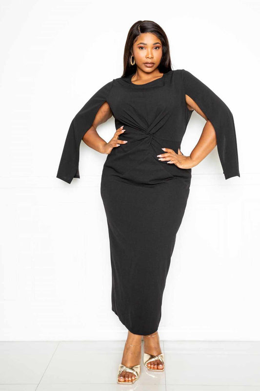 Plus size model wearing black cape sleeve dress with knot detail, available in 1XL, 2XL, 3XL, made of polyester and spandex.