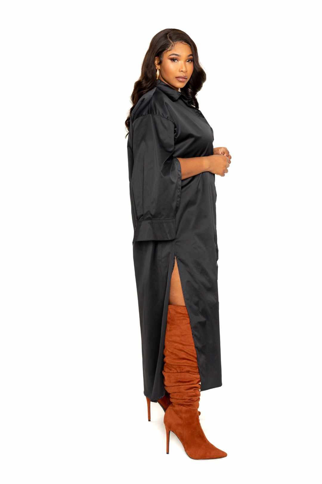 Black cape sleeve shirt dress in 1XL to 3XL, 100% polyester, side view with slit, paired with tall brown boots.