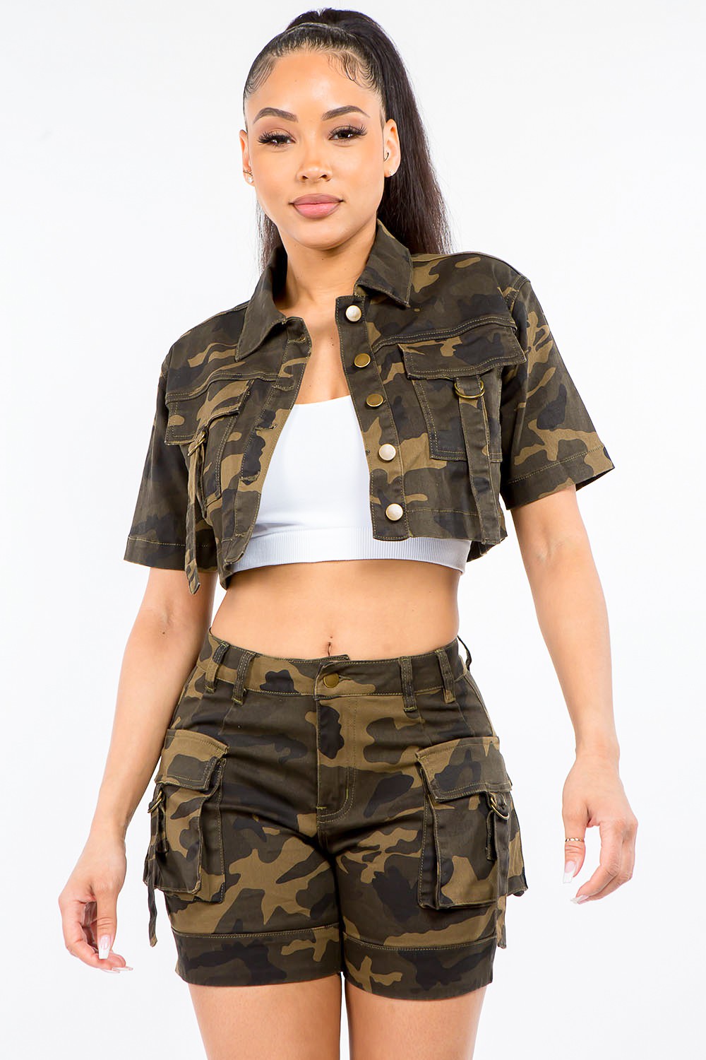 Woman wearing a full-size camouflage short sleeve cropped jacket with matching shorts, showcasing trendy casual fashion style.