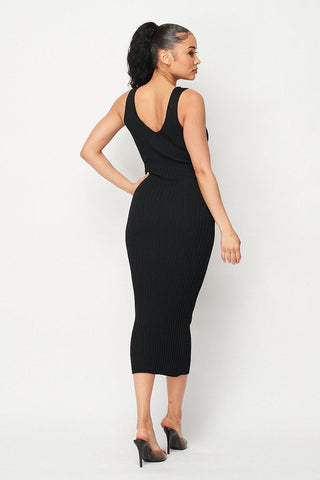 Woman wearing Carmen Ribbed Knit Midi Dress in black, showcasing the back view with intricate ribbed design, perfect for stylish comfort.
