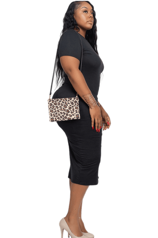 Plus size model in black drawstring midi dress with ruched side slit, leopard print clutch, and beige heels, side view.