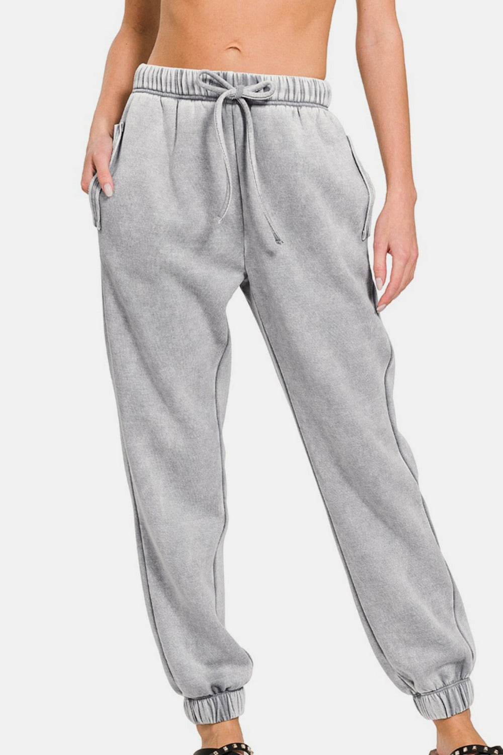 Acid wash fleece drawstring sweatpants with pockets, showcasing casual style and comfort for lounging or running errands.