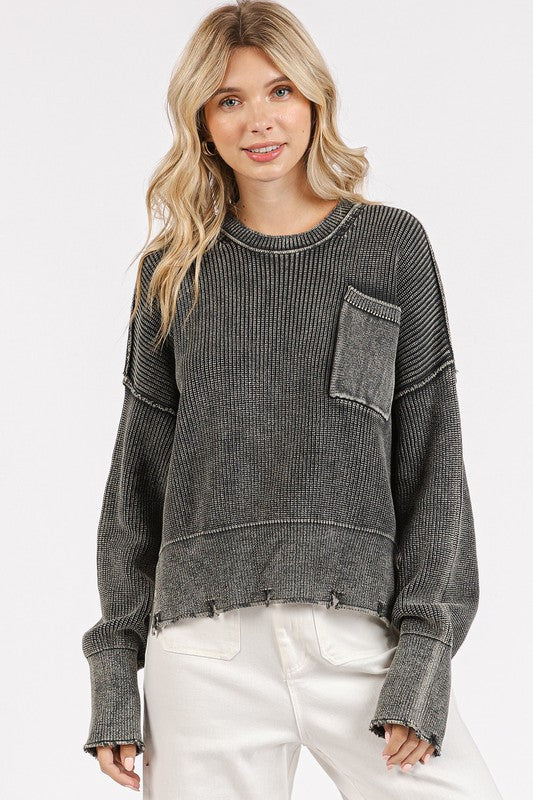 "Dark gray round neck sweater with exposed seams and slit distressed hem, made of 100% cotton."