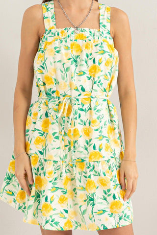 Yellow floral tie shoulder mini dress with ruched design, opaque cotton fabric, and no stretch. Perfect for sunny days.