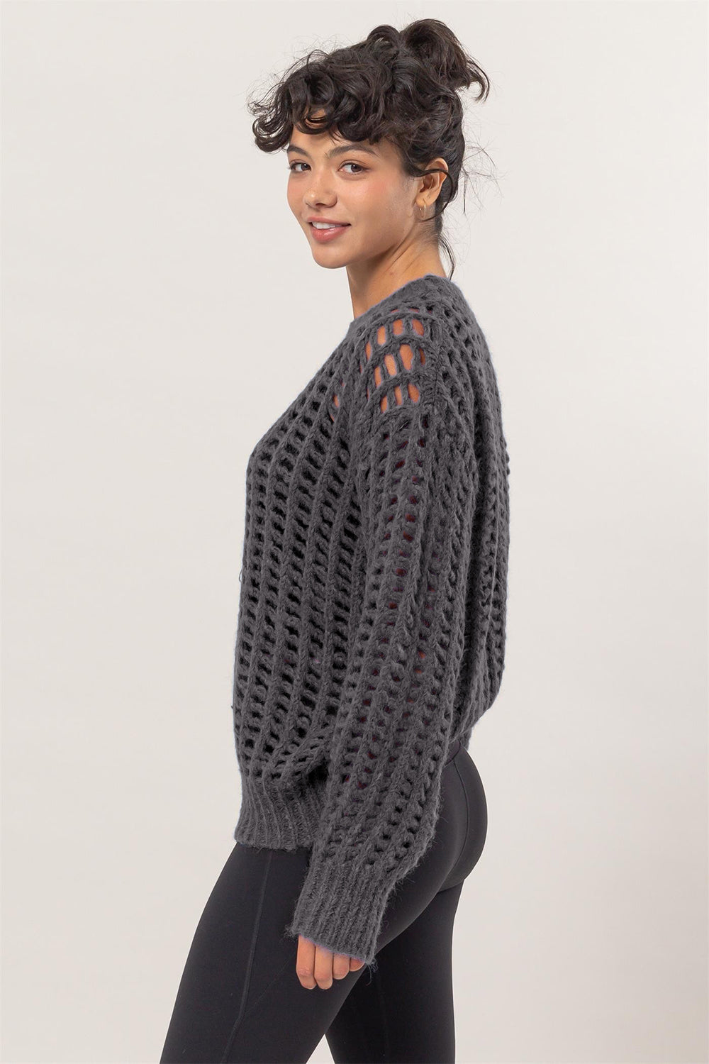 Woman wearing HYFVE openwork round neck long sleeve knit cover-up with chic plaid detailing.