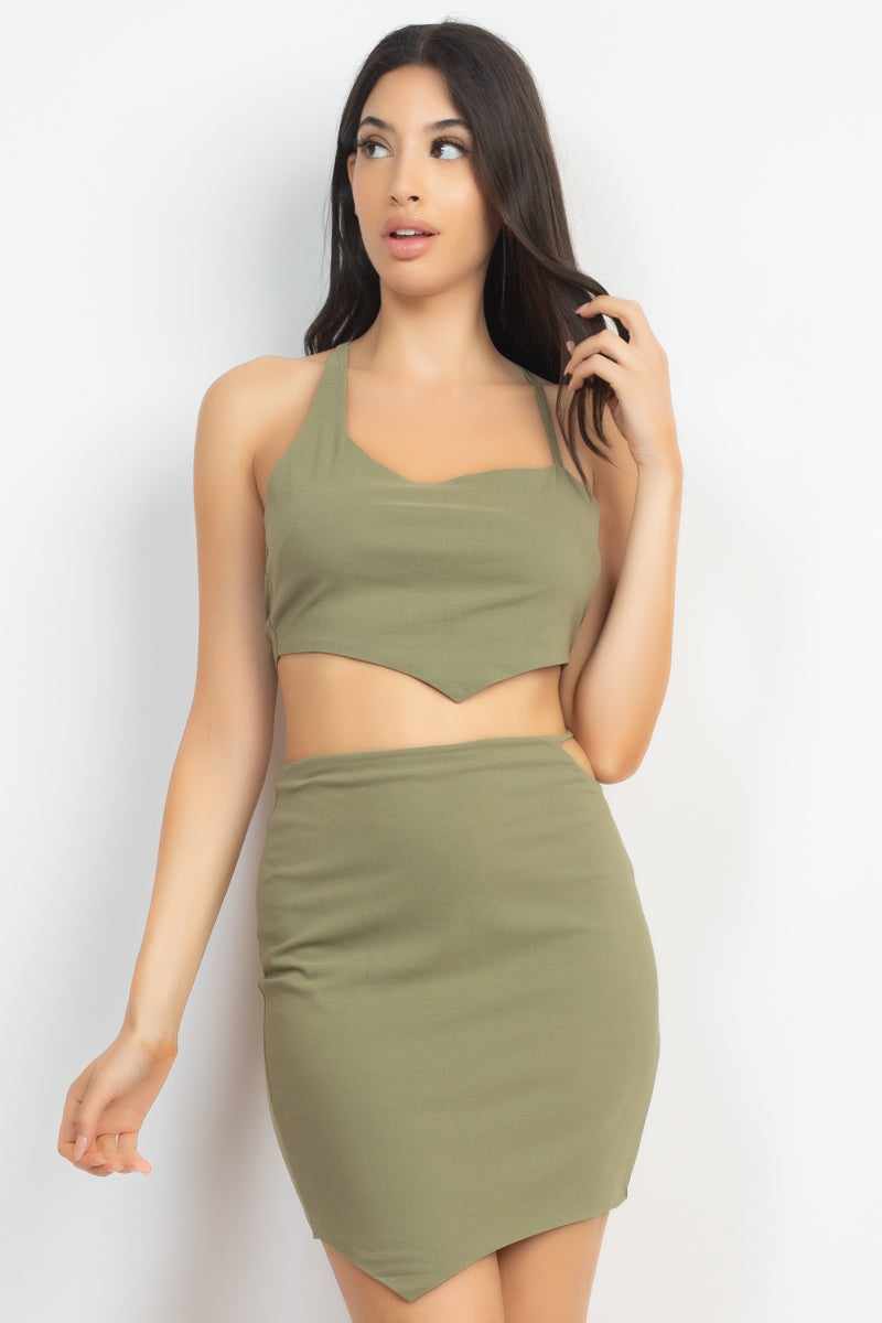 Olive asymmetrical cross back top and skirt set with scoop neckline, high-waist cutout, mini length, and crossed back detail.