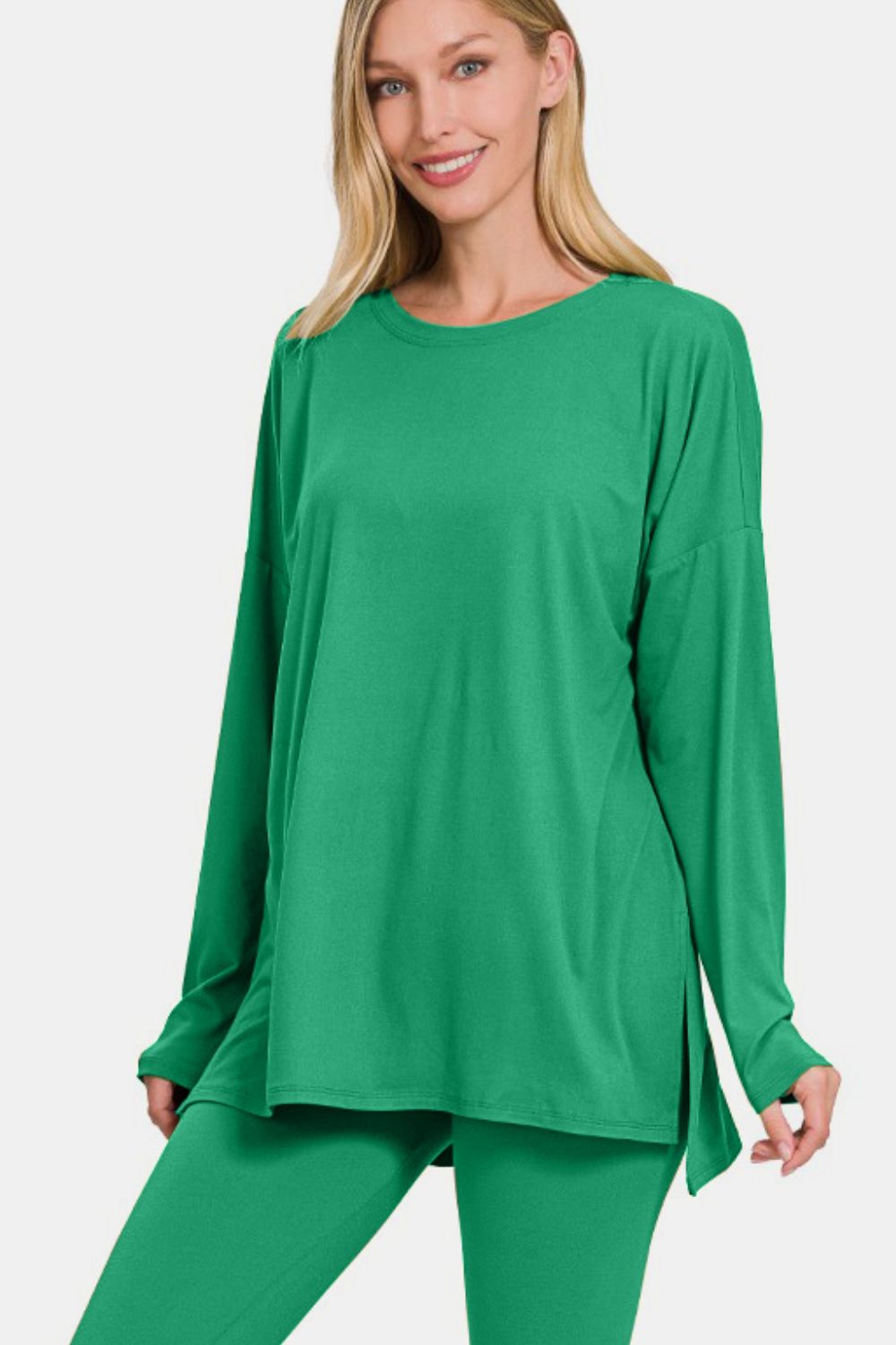 Woman wearing green brushed microfiber two-piece lounge set with long sleeve top and leggings, featuring a trendy slit detail.