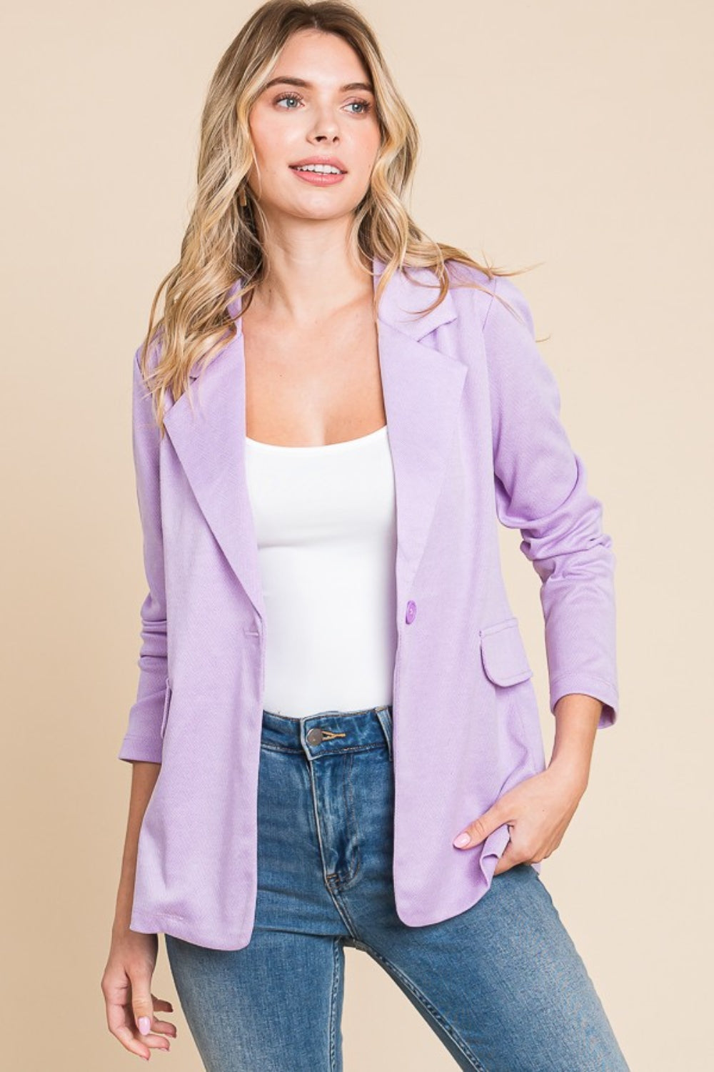 Woman wearing lilac button up long sleeve slit blazer with jeans, featuring basic style and normal thickness, made of polyester and spandex.