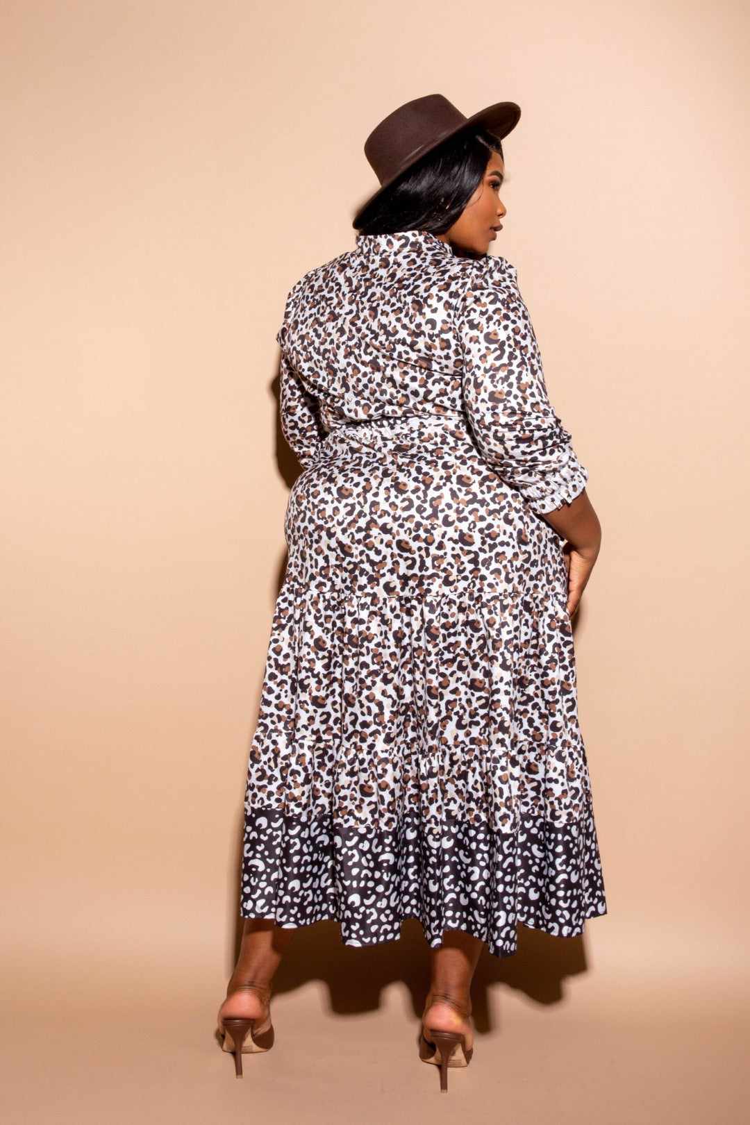 Plus-size model wearing a multi-color contrast animal print shirt dress with a hat, showcasing back view.