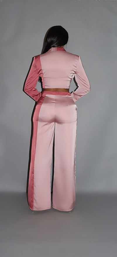 Woman modeling blush colorblock crop blazer with matching low rise wide leg pants, showcasing back view details.