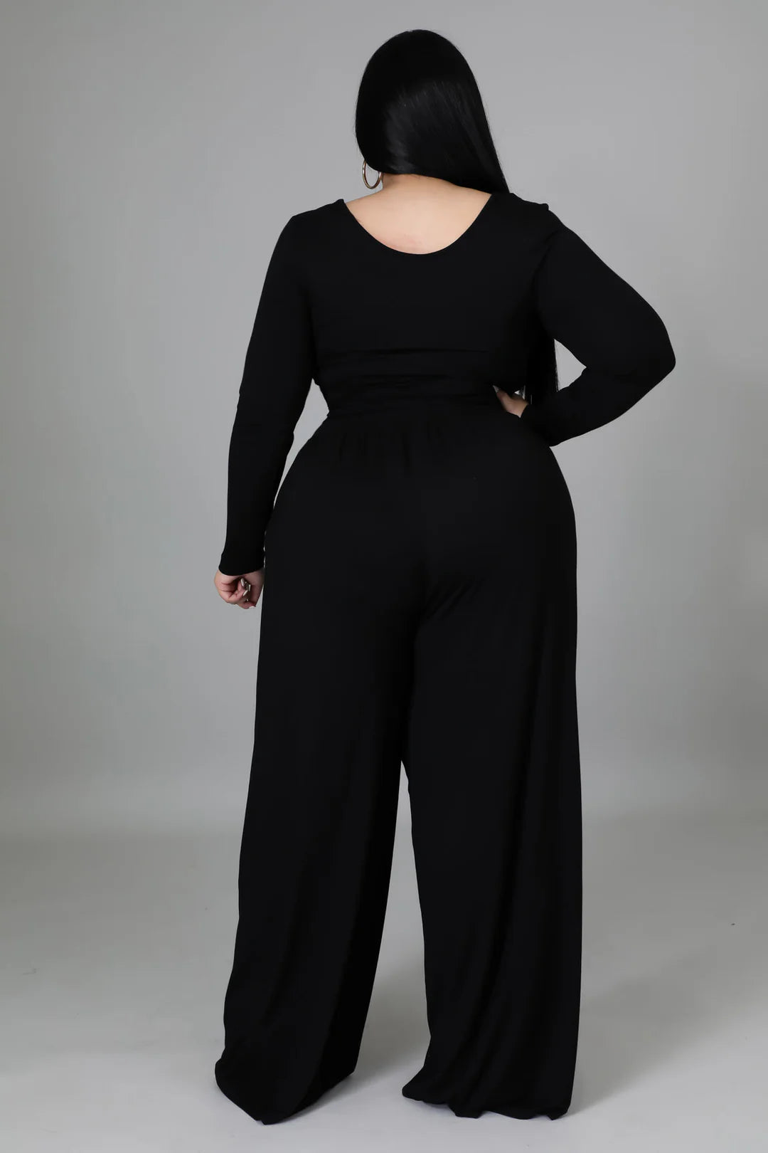 Woman in black long sleeve crop top and loose pants set with flattering fit and square neckline, showcasing chic fashion style.