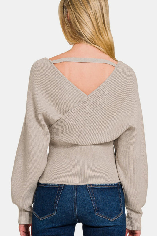 Woman wearing cross wrap rib long sleeve sweater in beige, showcasing chic design and flattering fit from the back.