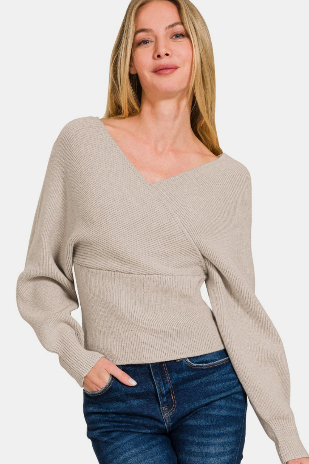 Chic cross wrap rib long sleeve sweater in soft beige, perfect for casual outings or layering, worn by a model with jeans.