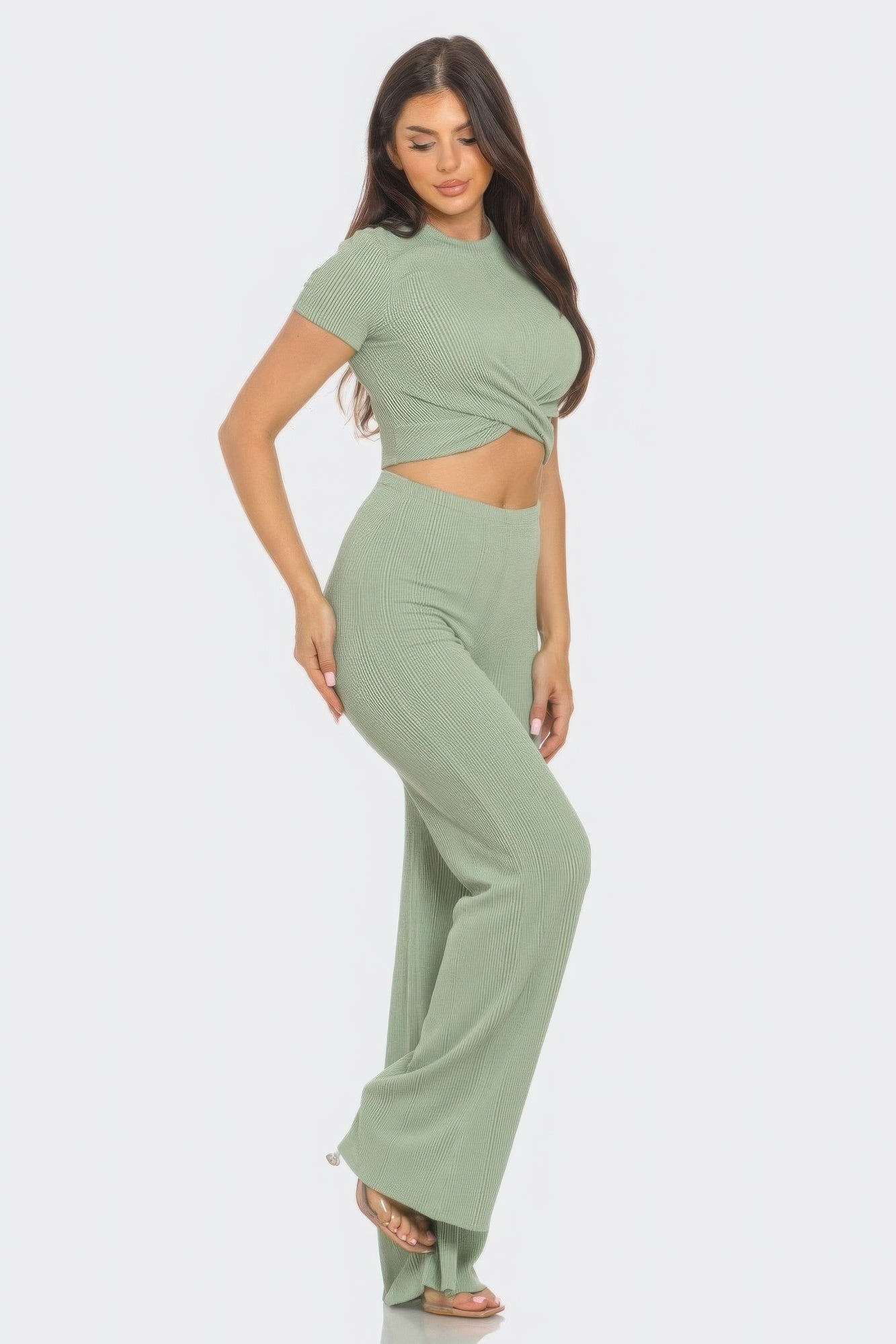 Woman wearing green front twist detail crop top and high-waisted flare pants set, perfect for chic daytime or night out look.