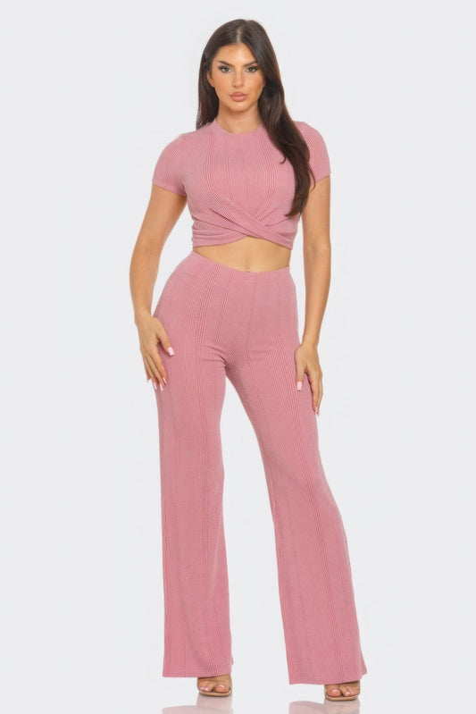 Chic front twist detail top and flare pants set in pink, featuring a trendy crop top with short sleeves and high-waisted retro flares.