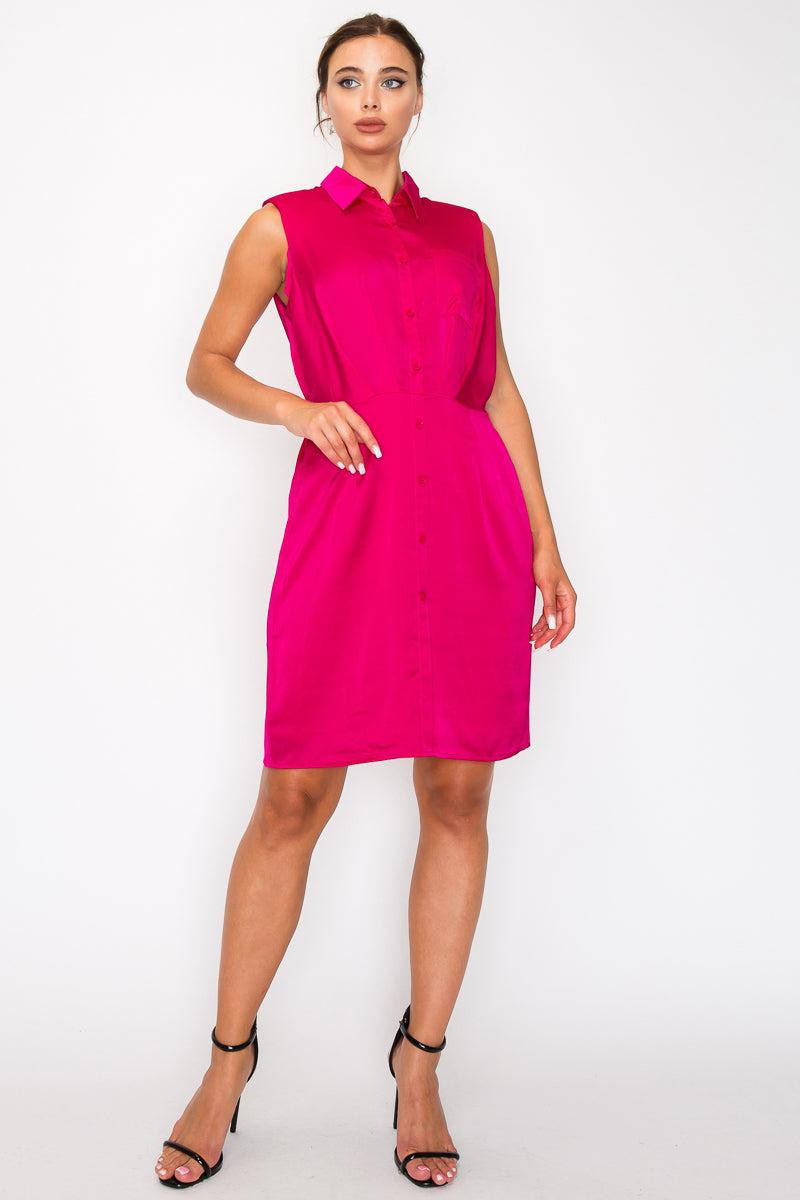 Woman wearing sleeveless fuchsia button-down pleated shirt dress with collar and cinched waist, knee-length design.