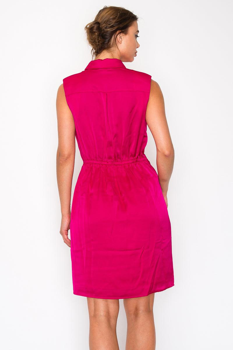 Fuchsia sleeveless pleated shirt dress with a collar, back view showing cinched waist and knee-length fit. 100% polyester.