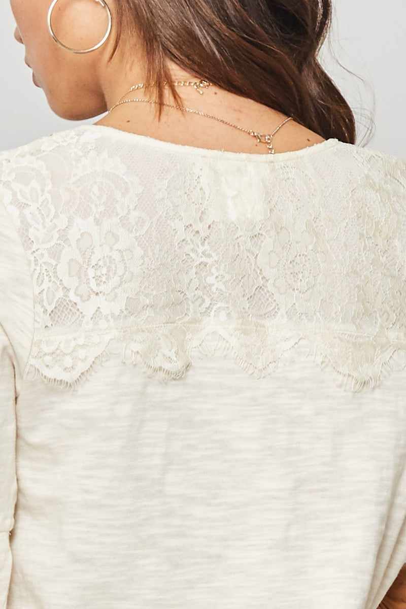 Back view of knit top featuring a floral eyelash lace yoke design in vanilla color.