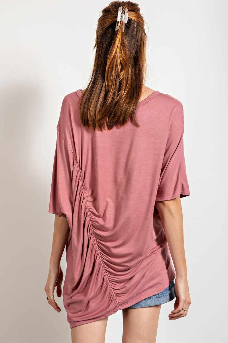 Mauve loose fit top with ruched side detailing and boat neckline, showcasing a longer tunic length and boxy silhouette.