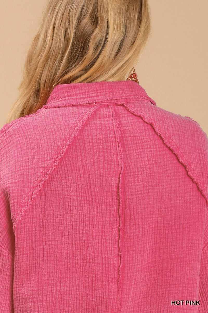 Hot pink mineral wash button down top with high low hem, back view showing textured fabric and collar detail.