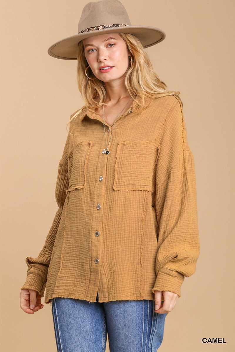 Camel mineral wash button down top with high low hem worn by model with beige hat and jeans.