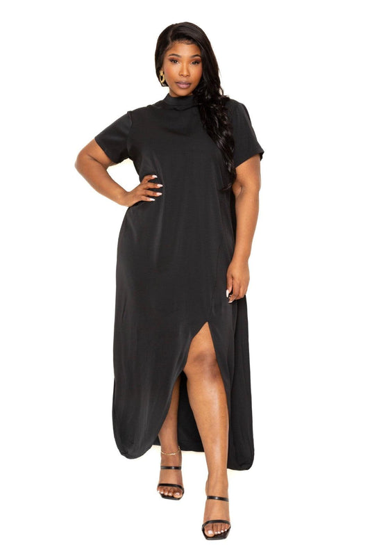 Plus-size woman wearing a black mock neck back cape dress with side slit, showcasing elegant style and high-stretch comfort.