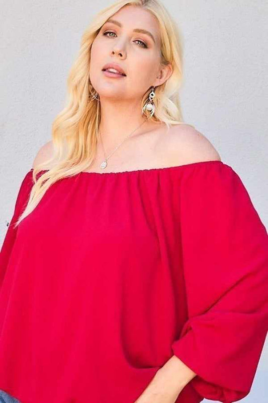 Plus size woman in burgundy off shoulder long bubble sleeve top