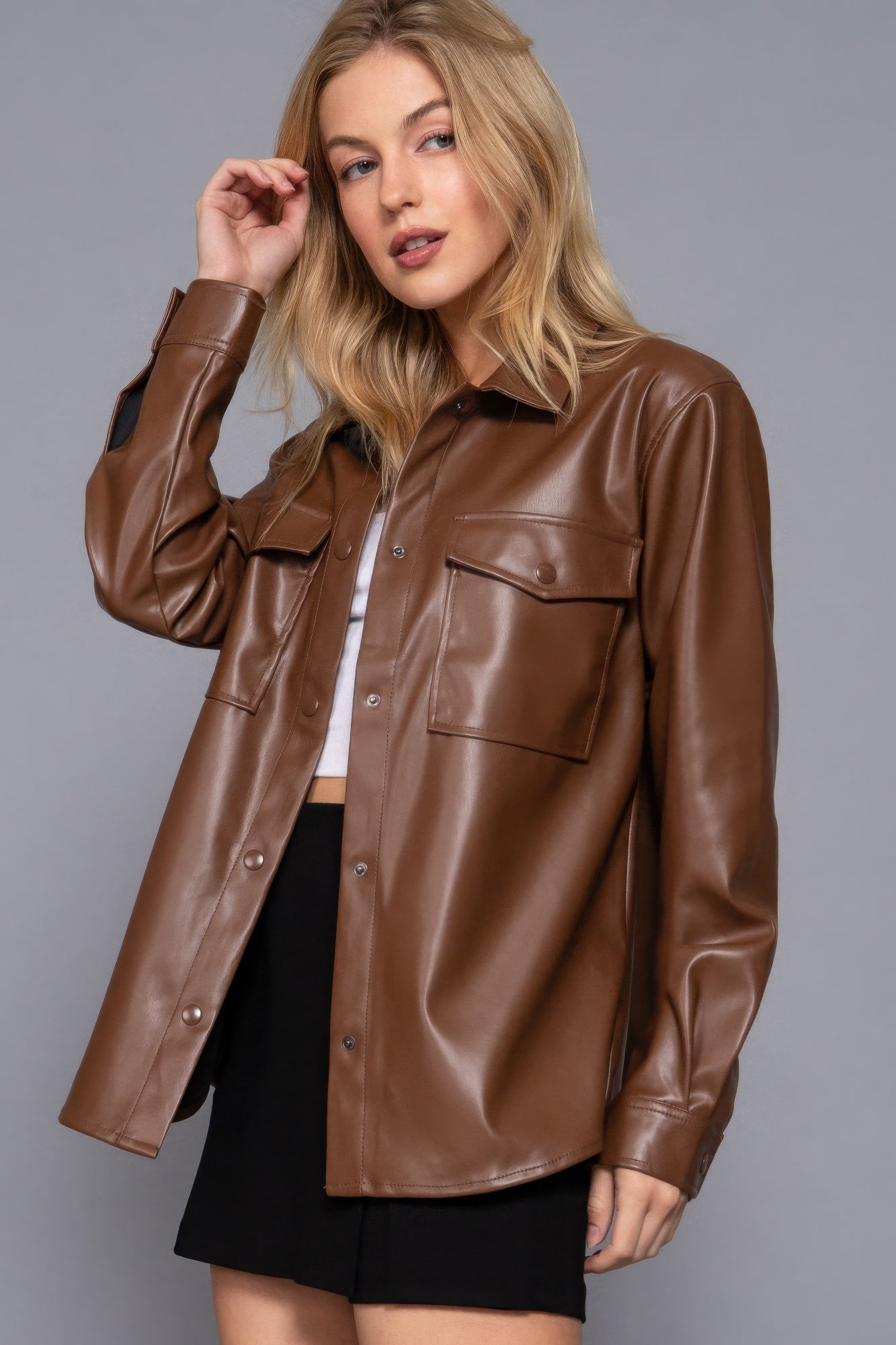 Stylish faux leather shacket in brown with long sleeves, perfect for layering and elevating any outfit.