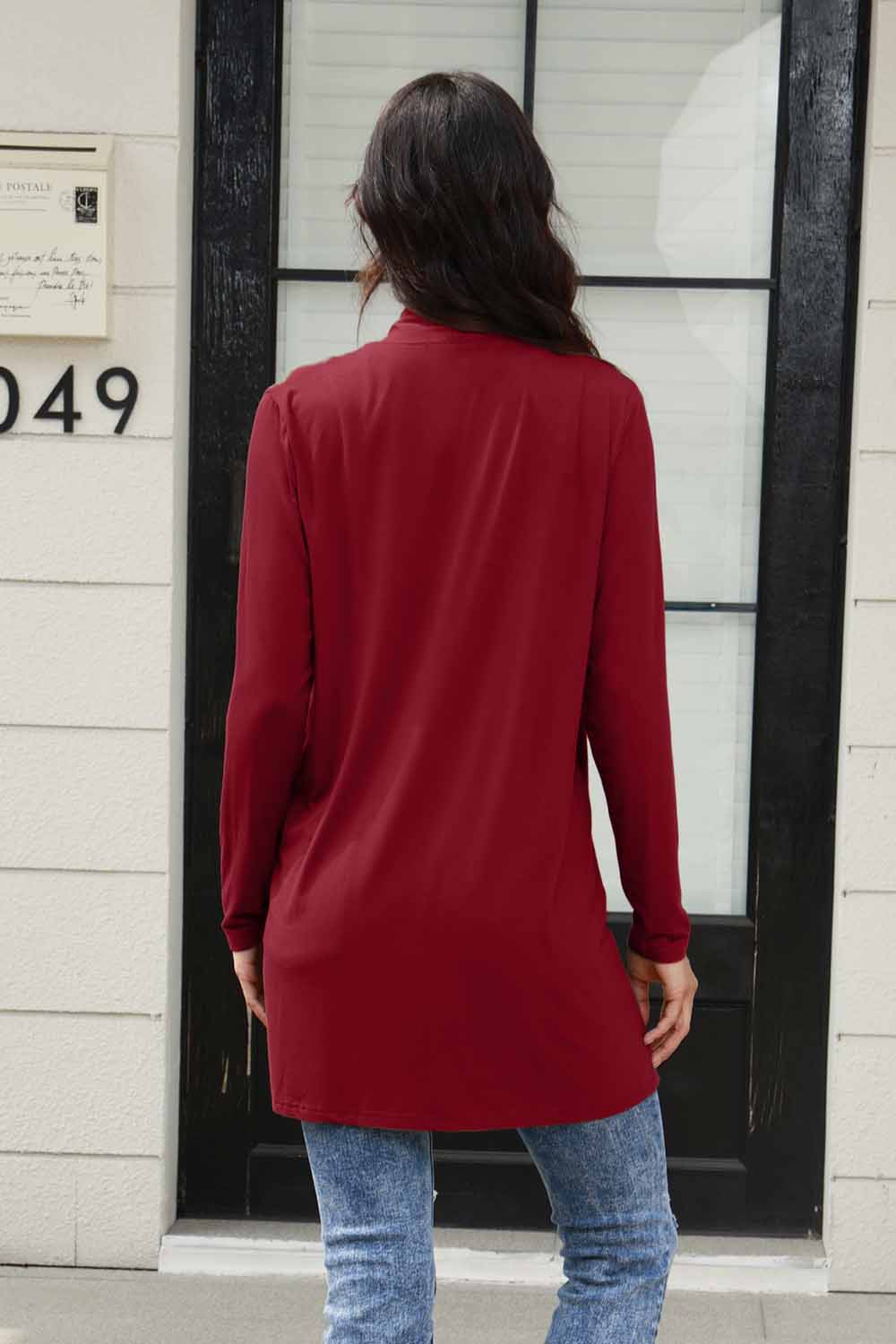 Red open front long sleeve cardigan with pockets, basic thin style, 100% polyester, shown on woman standing outdoors.