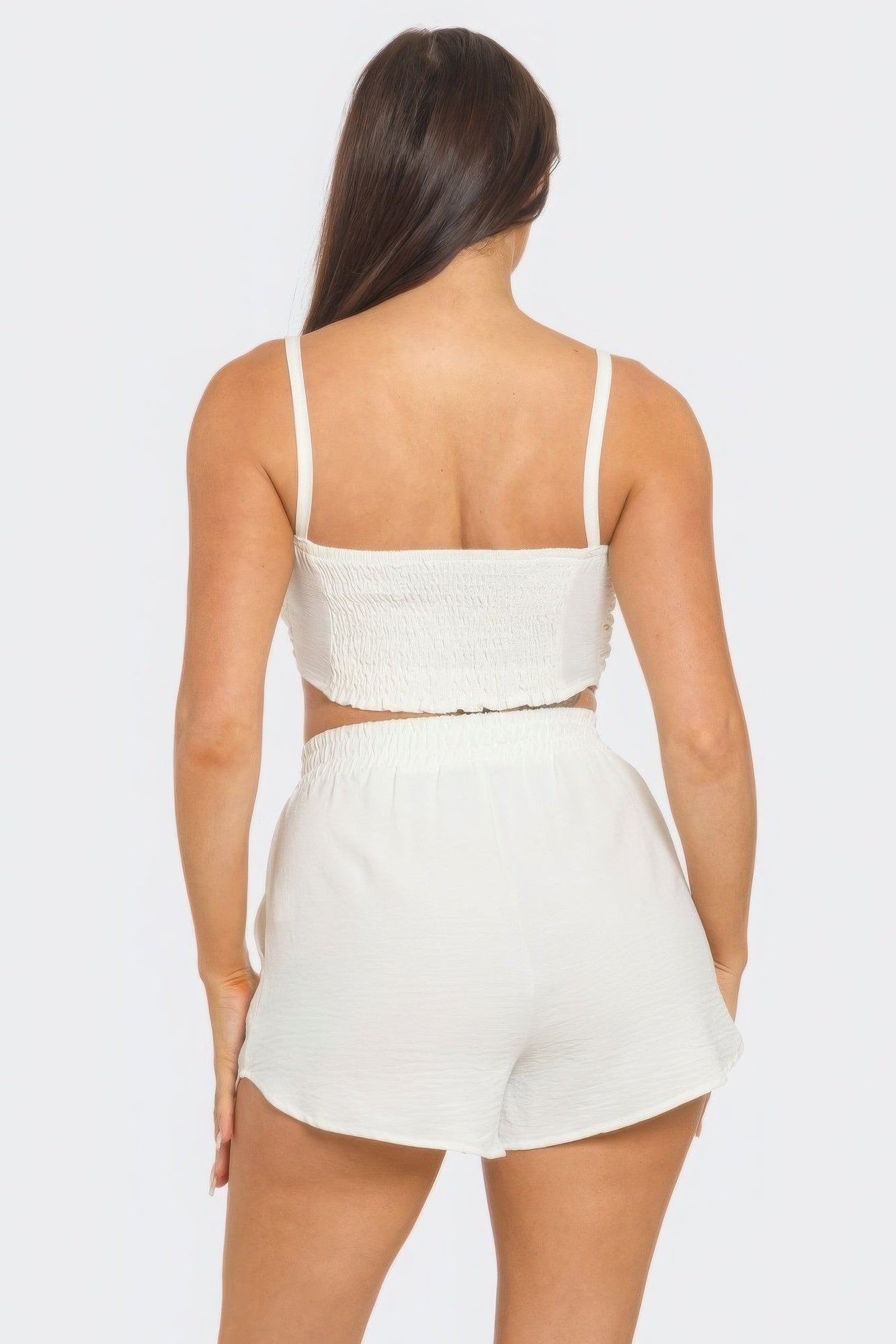 White shorts set with elastic waistband and shirred back, featuring a chic, comfortable design. Perfect for versatile styling.