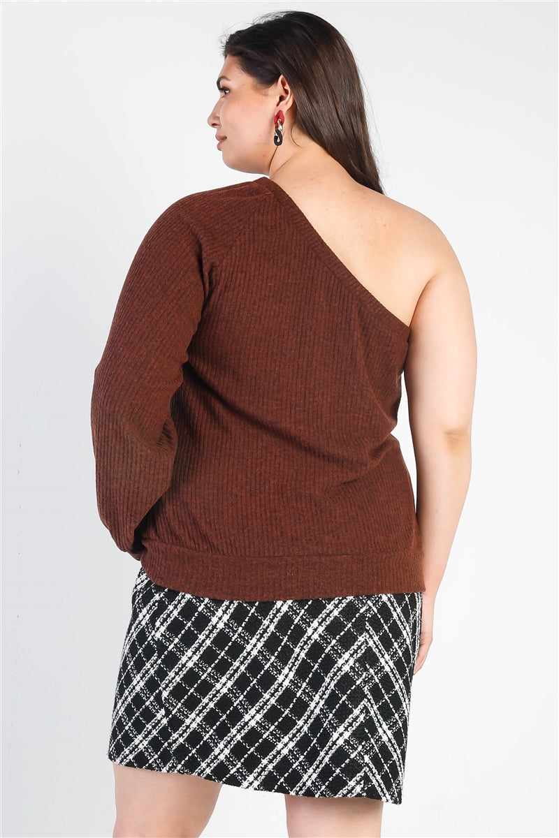 Plus size woman wearing a brown ribbed one shoulder top with relaxed fit, paired with a plaid skirt, showcasing casual trendy style.