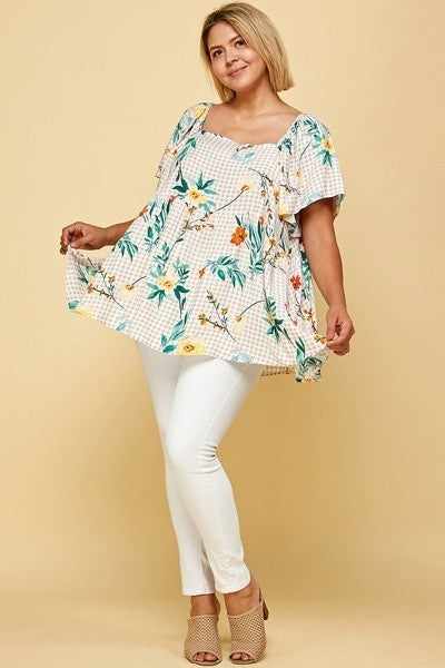 Plus size floral check square neck blouse with puff sleeves, model wearing taupe top pairing with white pants, stylish look