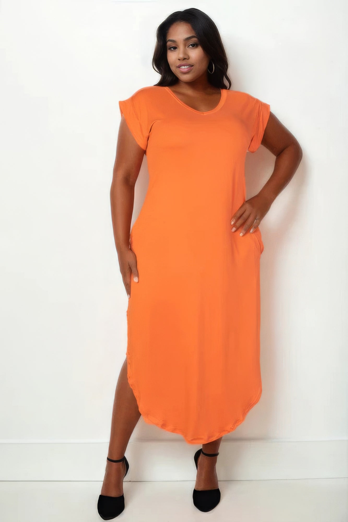 Plus size model wearing an orange V neck maxi dress with batwing sleeves and pockets, showcasing elegant style and comfort.