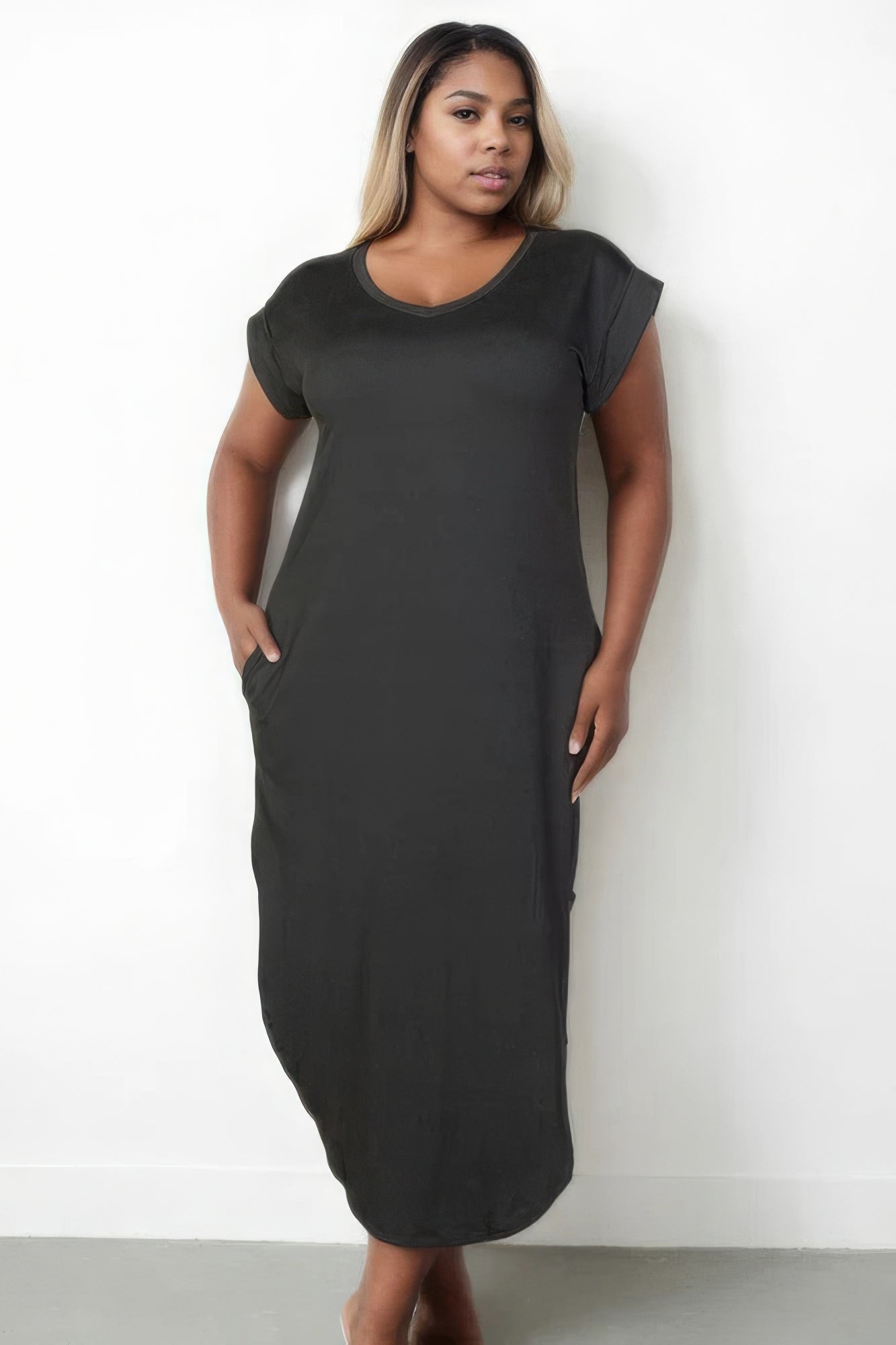 Plus size woman in chic V neck maxi dress with batwing sleeves and concealed pockets, showcasing elegant style and comfort.