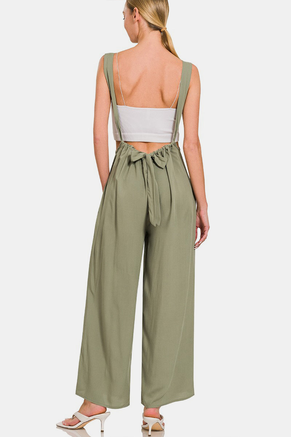 Stylish wide leg overalls with ruched detailing, adjustable tie closure, and pockets. Comfortable wide straps for chic all-day wear.