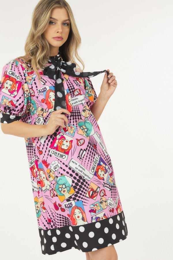 Woman wearing pink print midi dress with polka dot finish and tie, featuring playful cartoon design, made of 100% polyester.