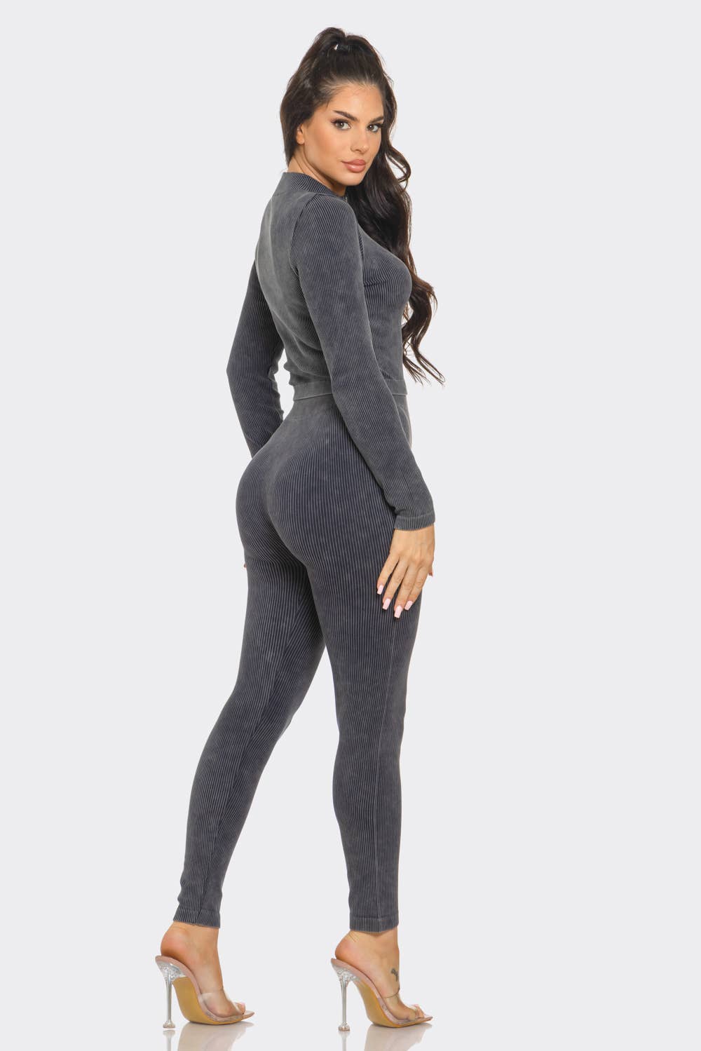 Woman wearing washed seamless rib zip up jacket and leggings set, showcasing back view with long sleeves and cropped style.