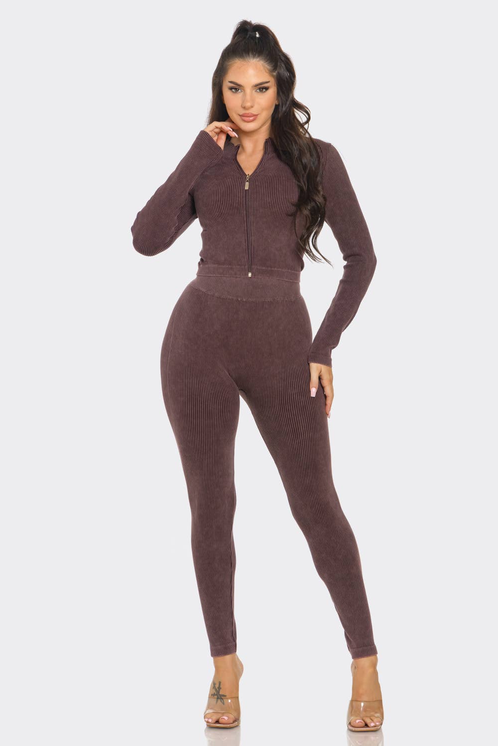 Woman wearing washed seamless rib zip up jacket and leggings set in a mock neck style, showcasing a fashionable and comfortable outfit.