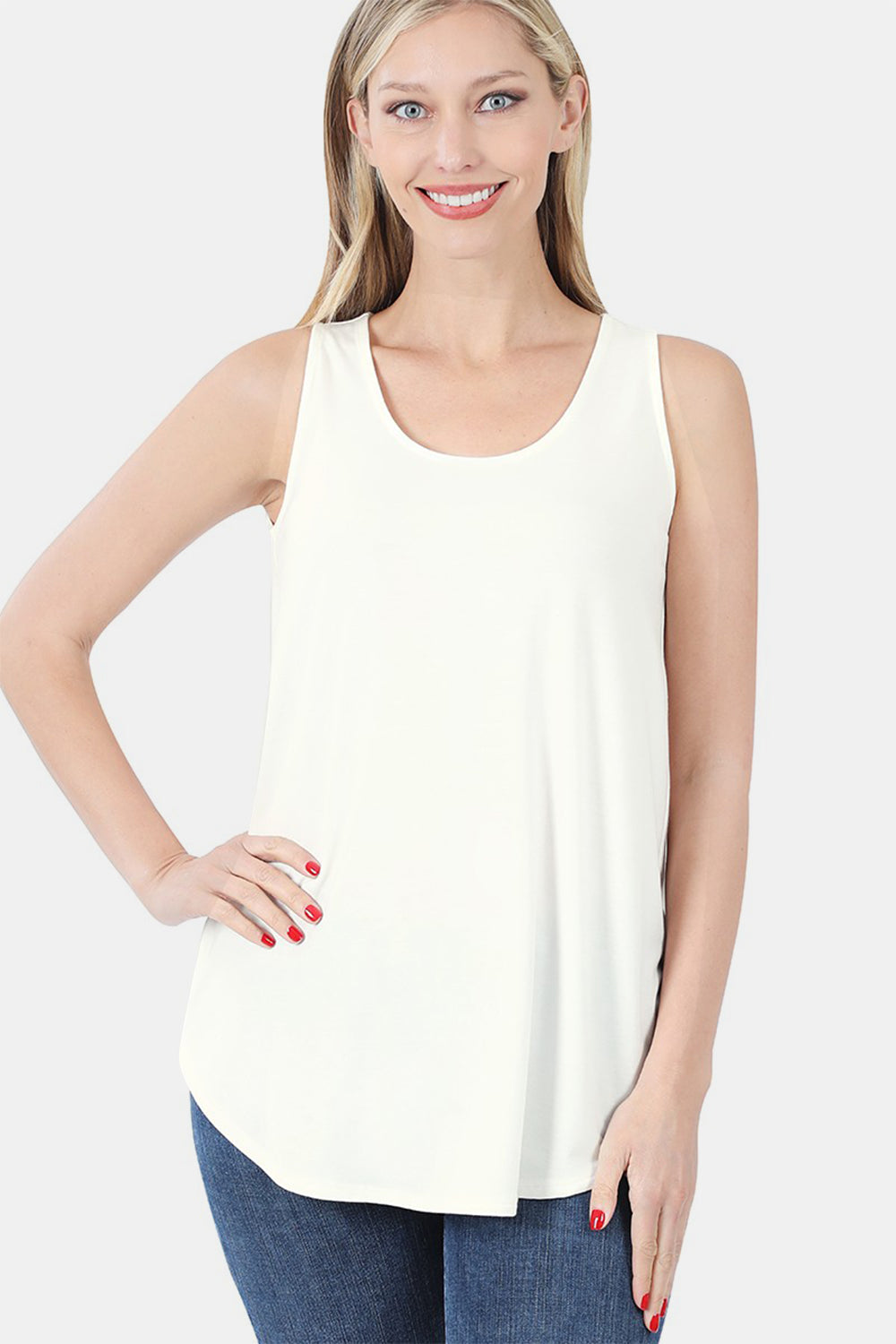 Woman wearing a round neck curved hem tank top in off-white with a flattering silhouette, perfect for versatile casual or layered looks.